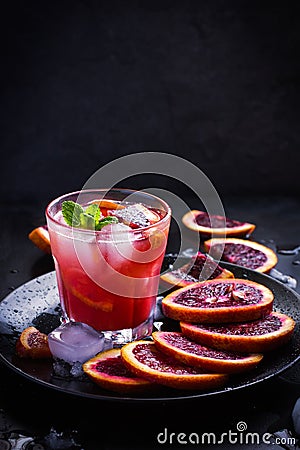 Refreshing cocktail with red blood orange, ice and mint Stock Photo