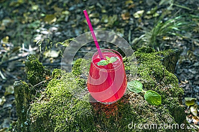 Refreshing cool summer lemonade from strawberry, raspberries, grapefruit or red currants. Pink cocktail drink in glass outdors on Stock Photo