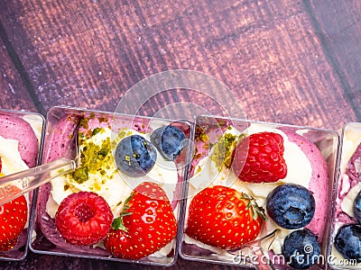 Ice cream, berries, strawberry, blueberry, raspberry, pistachios, nuts, sorbet, jam and biscuit, summer dessert, sweet snack Stock Photo