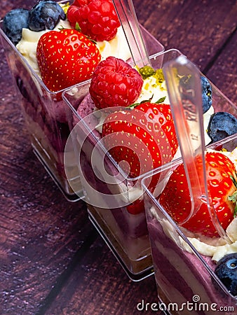 Ice cream, berries, strawberry, blueberry, raspberry, pistachios, nuts, sorbet, jam and biscuit, summer dessert, sweet snack Stock Photo