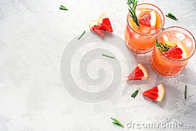 Refreshing grapefruit cocktail with ice and rosemary. Stock Photo
