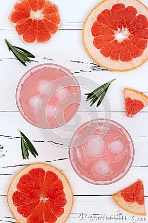 Refreshing grapefruit and rosemary cocktail over old vintage wooden table. Stock Photo