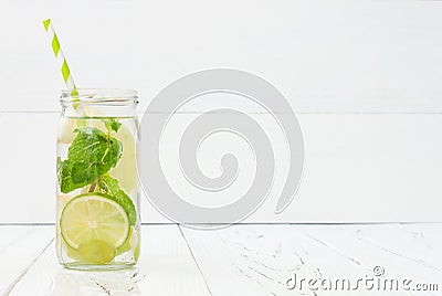 Refreshing homemade lime and mint cocktail over old vintage wooden table. Detox fruit infused flavored water. Clean eating Stock Photo