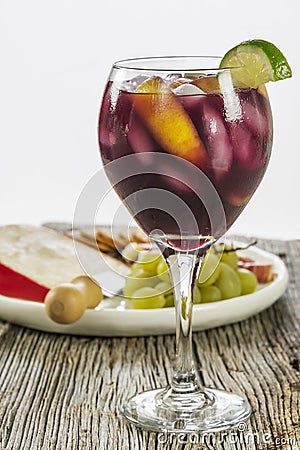 Refreshing ice cold fruit filled red sangria with appetizers Stock Photo