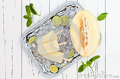 Refreshing ice pops over silver tray. Lime, honeydew white sangria paletas - popsicles. Top view Stock Photo