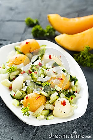 Refreshing melon salad with cucumber and chili Stock Photo