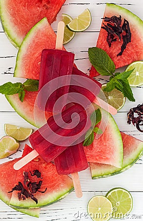 Refreshing mexican style ice pops - watermelon, hibiscus, lime paletas - ice pops - popsicles, served on watermelon slices with li Stock Photo