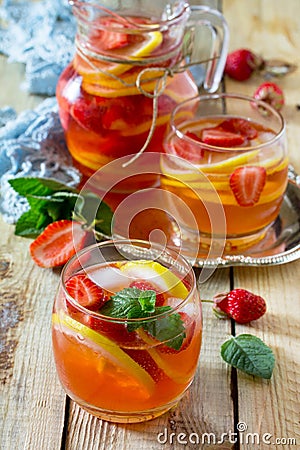 Refreshing summer drink strawberry mojito on a wooden table. The concept of eating vegetarians, fresh vitamins Stock Photo