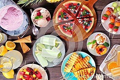 Refreshing summer food table scene, top view over dark wood Stock Photo