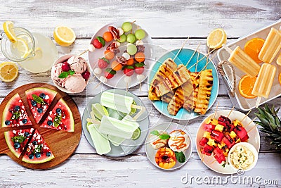 Refreshing summer food table scene, top view over white wood Stock Photo