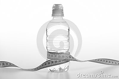 Refreshment and healthy regime symbol. Water bottle tied with cyan measure tape on white background Stock Photo