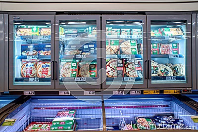 Refrigerated counters with frozen pizza packs Editorial Stock Photo