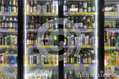 Refrigerated glass showcases with alcoholic beverages in the store. Blurred. Front view Stock Photo