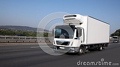 Refrigeration truck is driving on highway Stock Photo