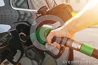 Refueling the car at a gas station fuel pump. Man driver hand refilling and pumping gasoline oil the car with fuel at he refuel st Stock Photo