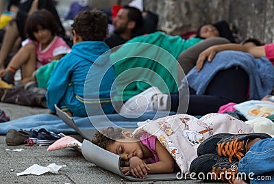 Refugee child sleeping at Keleti train station in Hungary Editorial Stock Photo