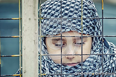 A refugee girl from the east in a headscarf Stock Photo
