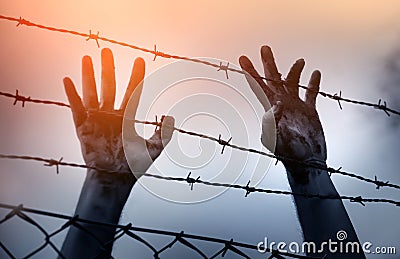 Refugee men and fence Stock Photo