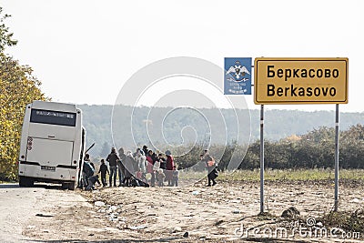 Refugees getting off the bus that brought them in Serbia to enter the EU at border village of Berkasovo between Serbia & Croatia Editorial Stock Photo