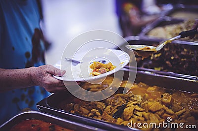 Refugees` hands are receiving food from philanthropists: the concept of hunger problems for the poor Stock Photo