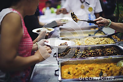 Refugees` hands are receiving food from philanthropists: the concept of hunger problems for the poor Stock Photo