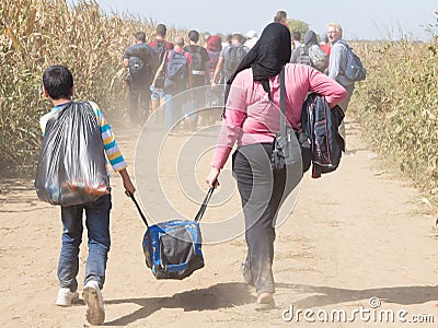 Refugees walking through the fields near the Croatia Serbia border, between the cities of Sid Tovarnik on the Balkans Route Editorial Stock Photo