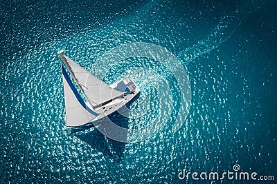 Regatta sailing ship yachts with white sails at opened sea. Aerial view of sailboat in windy condition Stock Photo