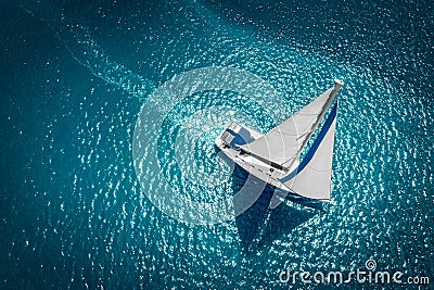 Regatta sailing ship yachts with white sails at opened sea. Aerial view of sailboat in windy condition Stock Photo