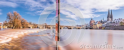 Panorama flood of the river Danube in winter 2021 in Regensburg with view of the cathedral the old town and flooded promenade and Editorial Stock Photo