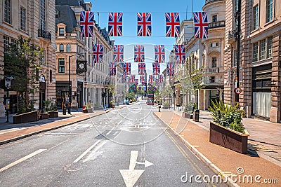Regent Street Saint James in London scenic street view with UK flags Editorial Stock Photo