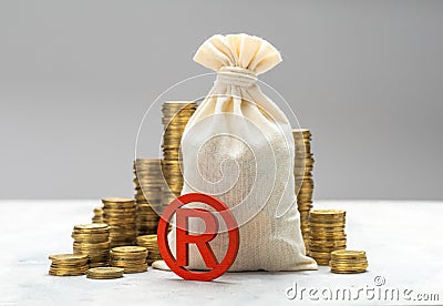 Registered trademark and money bag with gold coins on gray background Stock Photo