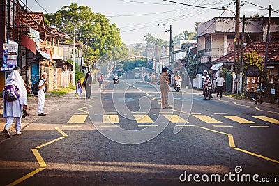 Regular public Sri Lankan bus stop. Policeman control moring traffic in the city Ambalangoda Editorial Stock Photo