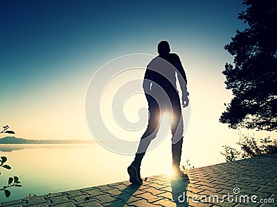 Regular run at lake. Man runner sprinting outdoor in scenic nature Stock Photo