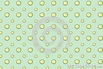 Regular seamless pattern of cucumber slices on a mint background. Stock Photo