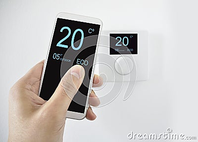Regulating the temperature with smartphone Stock Photo
