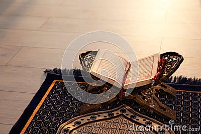 Rehal with open Quran and Muslim prayer beads Stock Photo