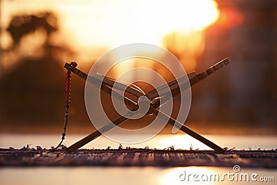 Rehal with open Quran and prayer beads on Muslim prayer mat Stock Photo