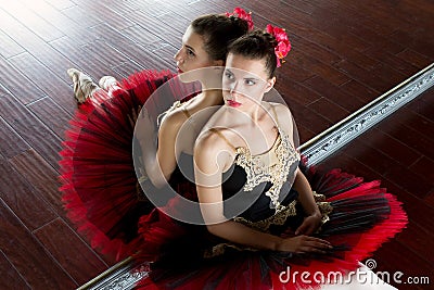Rehearsal ballerina in the hall. Light white room, wooden floor, large mirrors. Ballerina reflected in the mirror Stock Photo