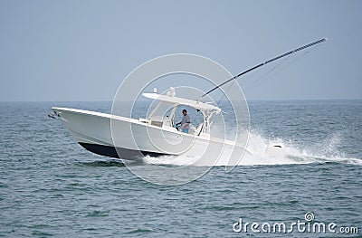 A white boat moving very fast on the bay near Rehoboth Beach, Delaware, U.S Editorial Stock Photo