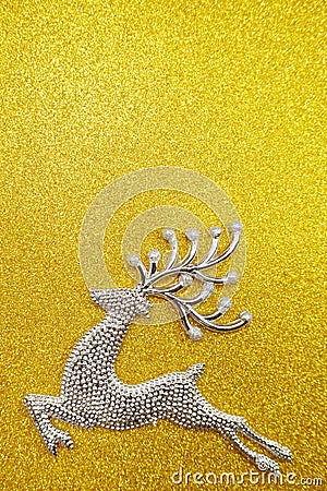 Reindeer and white berry Christmas decoration on yellow glitter background Stock Photo