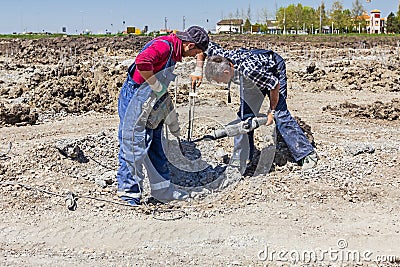 Reinforced concrete pillar picking from foundation of a new building. Editorial Stock Photo