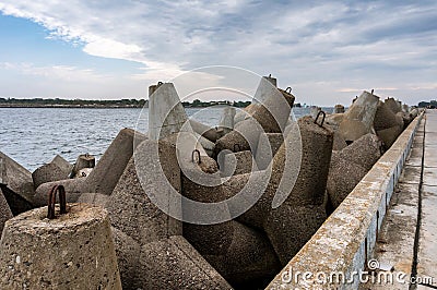 Coastal concrete fortifications. Reinforced concrete structures along the sea pier Stock Photo