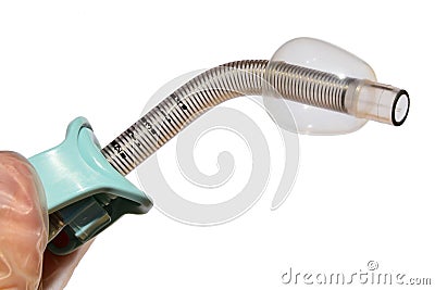 Reinforced fenestrated tracheostomy tube with inflated cuff held in left hand of doctor in latex glove, white background Stock Photo