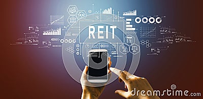 REIT - Real Estate Investment Trust theme with hand pressing a button Stock Photo