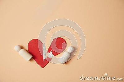 Relationship breakdown mockup. Broken heart. End of love. Divorce and separation. Red heart and wooden people figures Stock Photo