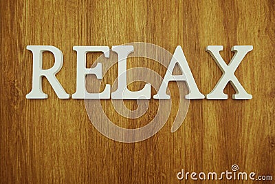 Relax alphabet letters on wooden background Stock Photo