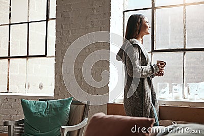 Relax, coffee and woman looking out window from her home, thinking and daydreaming on a quiet morning. Daydream, tea and Stock Photo