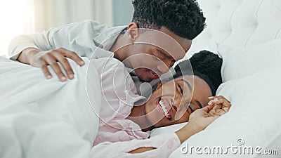 Relax, couple and love in bedroom kiss, rest and comfort in happy relationship together at home. Man and woman lying in Stock Photo