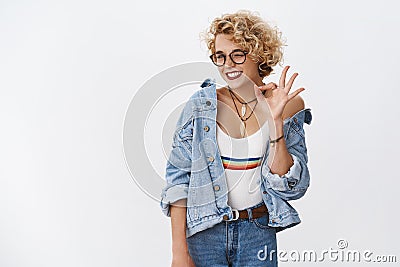 Relax everything ok. Portrait of chill and joyful carefree stylish and unbothered fair-haired female in 20s wearing Stock Photo