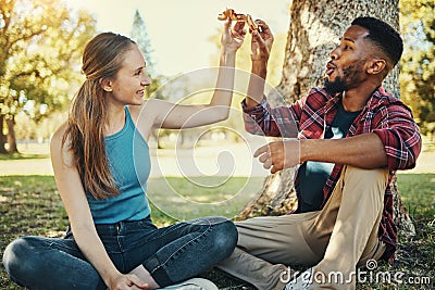 Relax, pizza and happy with couple in park for picnic, fast food and summer date. Love, youth and freedom with black man Stock Photo